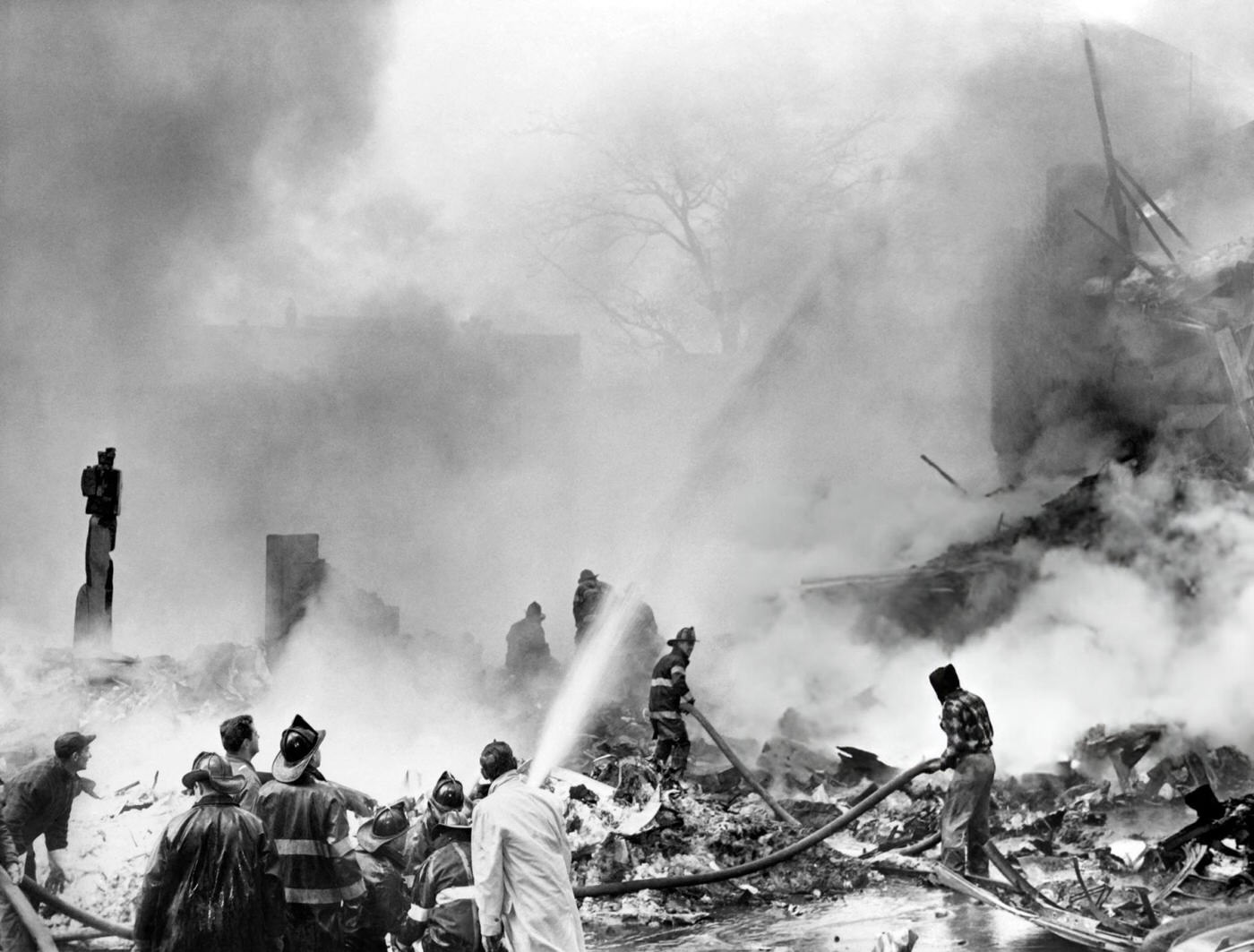 Firefighters Search For Victims At The Scene Of The Plane Crash In Brooklyn After A Collision Between Two Airliners, United Airlines Flight 826 And Trans World Airlines Flight 266 Over New York City, 1960.