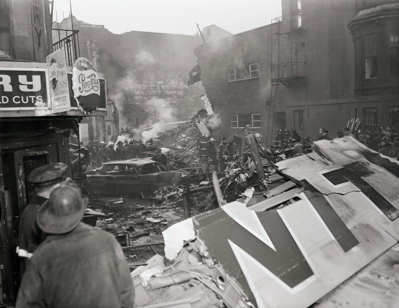A United Dc-8 Jetliner Crashed Into The Street After Colliding With A Twa Super Constellation Over New York City, Starting A Fire In A Row Of Brownstone Houses, 1960.