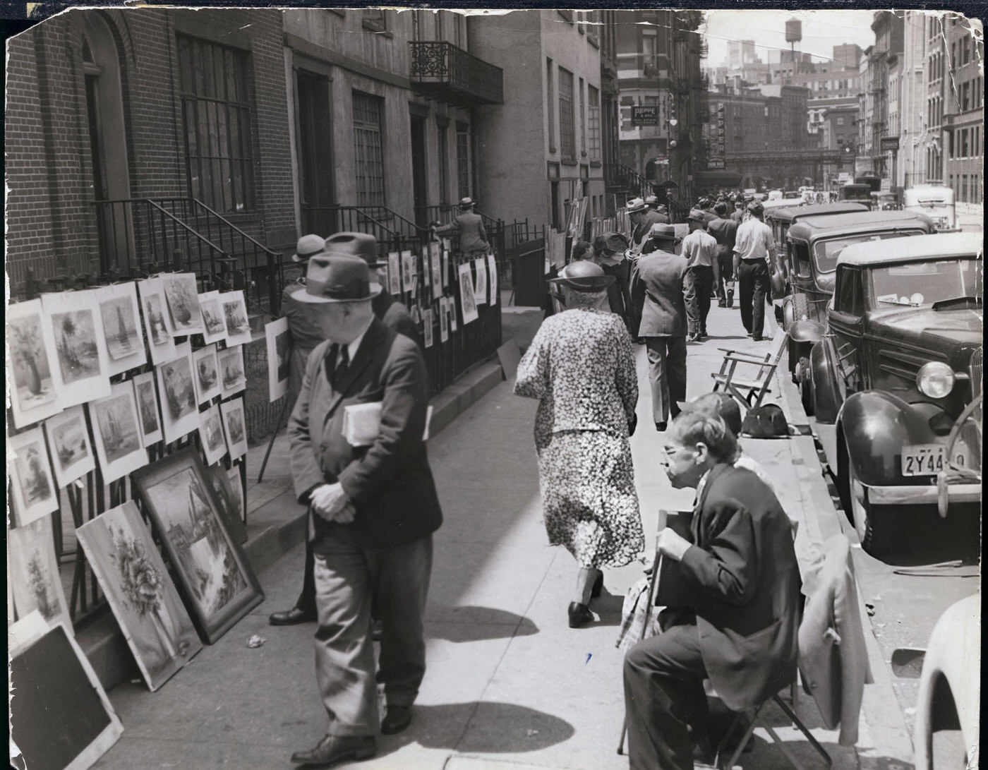 Pedestrians Browse Through The Art Exhibition In Washington Square.