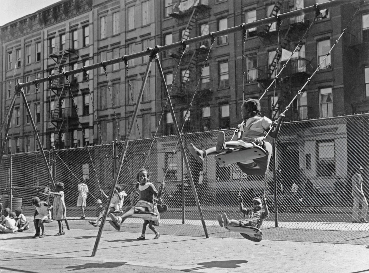 African-American Children Playing On Swings At A Harlem Playground, 1935.