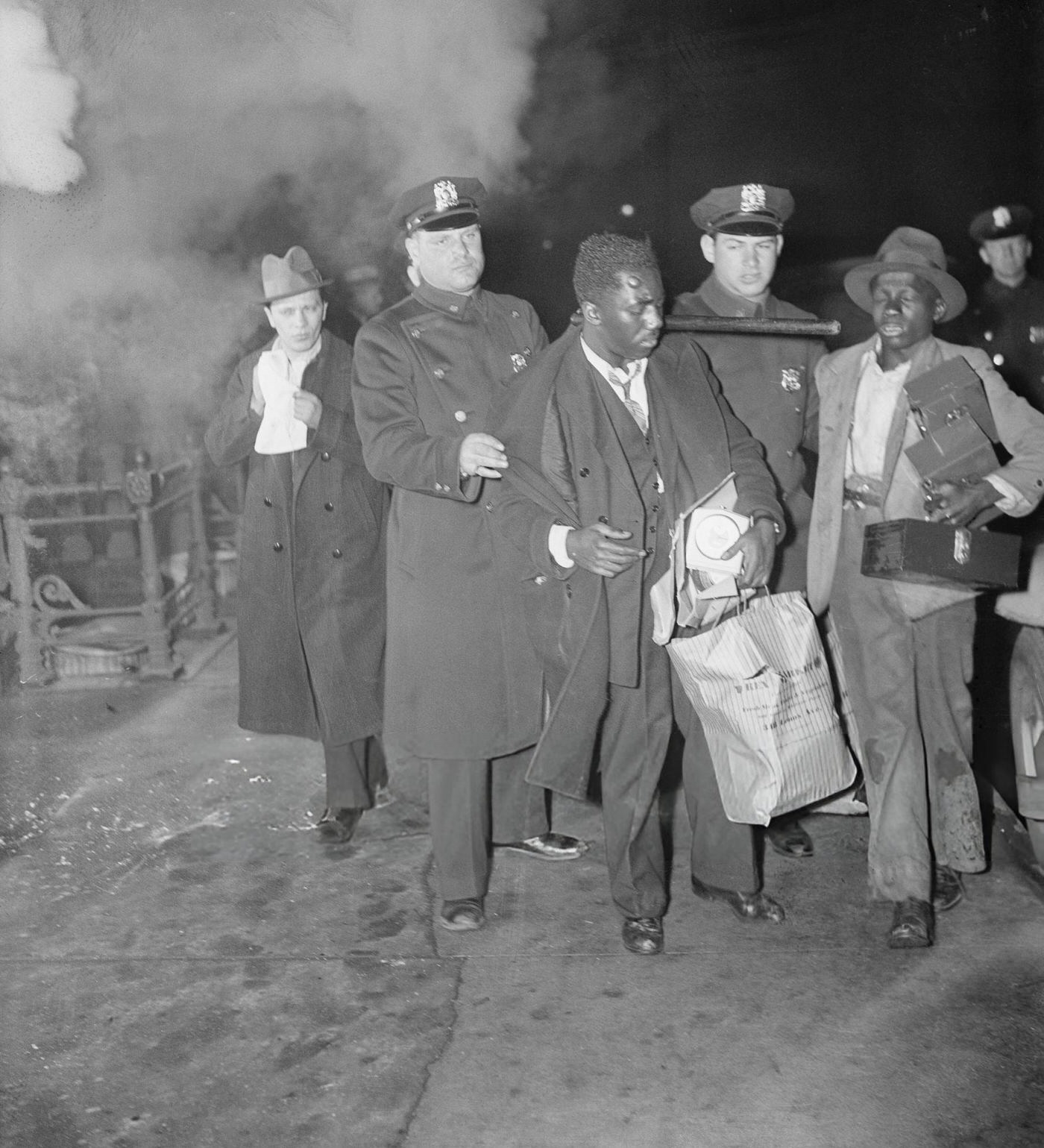 Police Escorting Suspects After A Night Of Rioting In Harlem.
