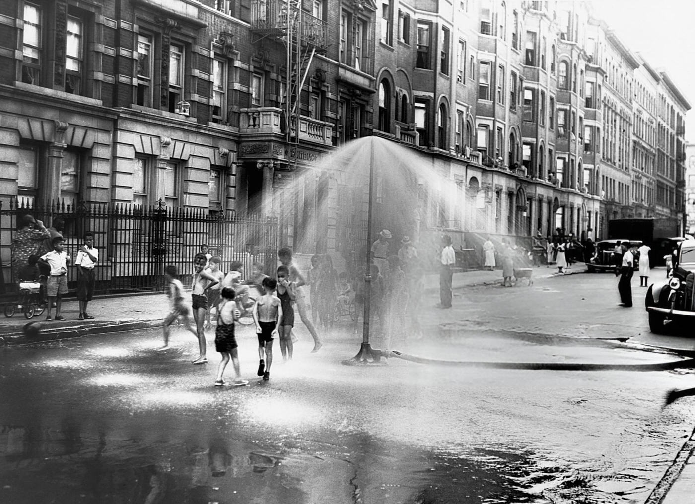 Children Playing In Water Sprayed From A Sprinkler In South Harlem, 1937.