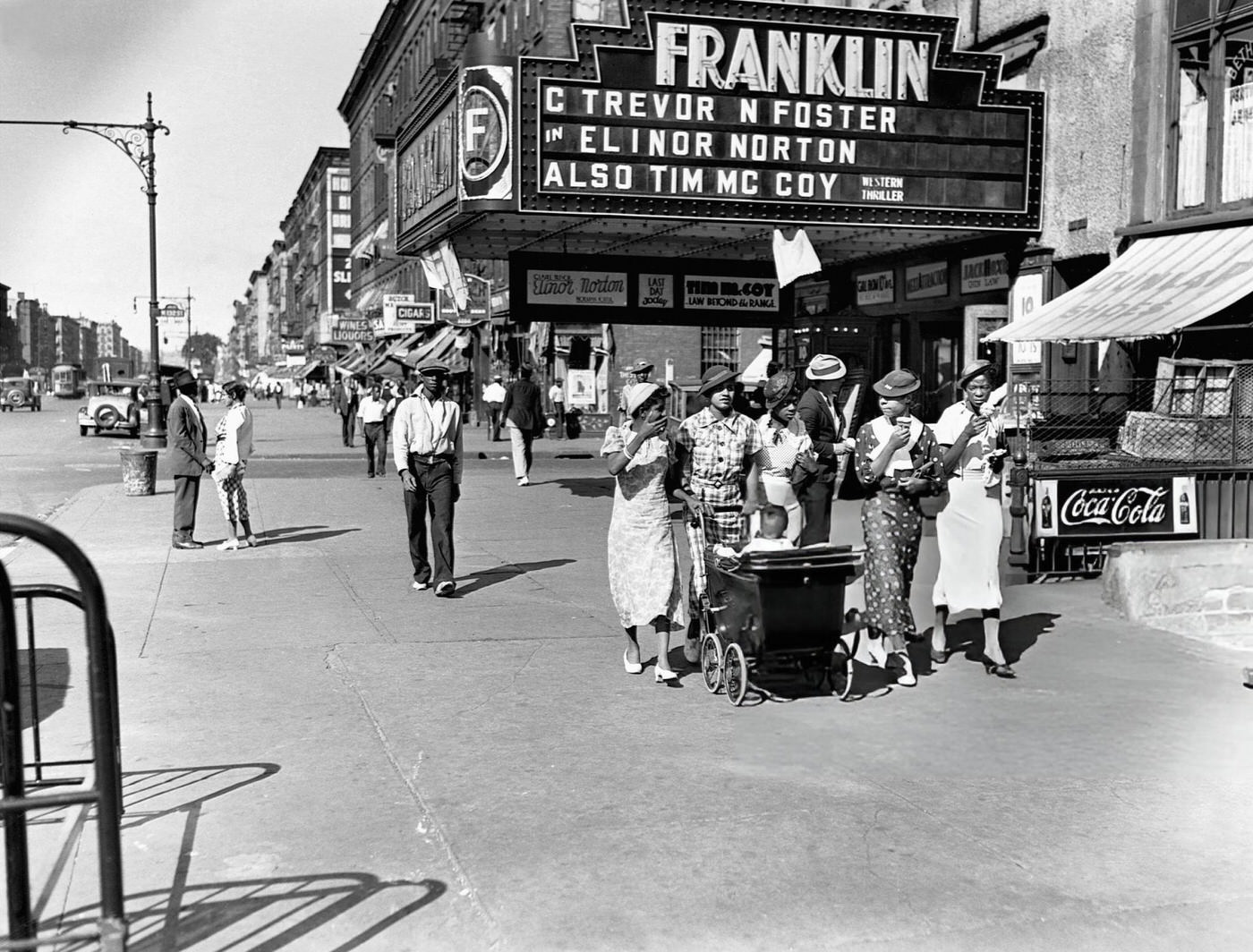 Pedestrians Stroll Down A Sidewalk On A Summer Day In Harlem, 1935.