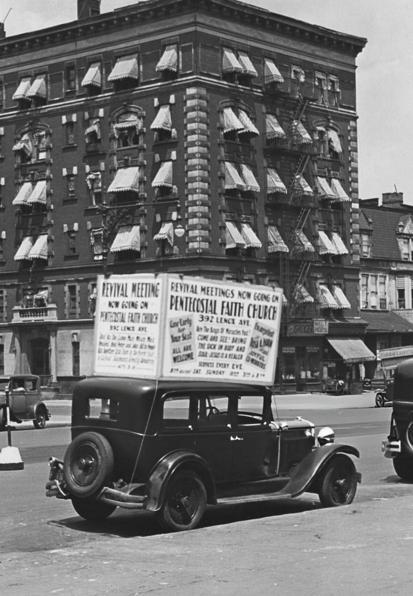 A Car With A Sign For The 'Pentecostal Faith Church' Parked On A Street In Harlem, 1935.