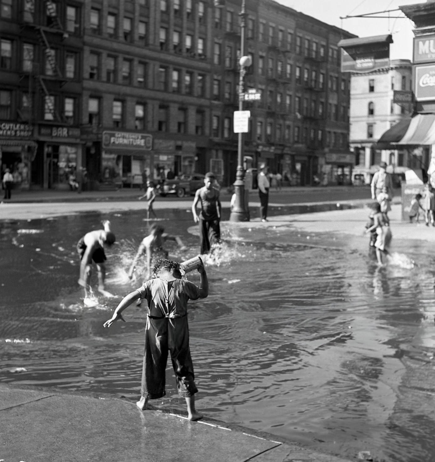 Children Playing In A Water-Filled Street In Harlem.