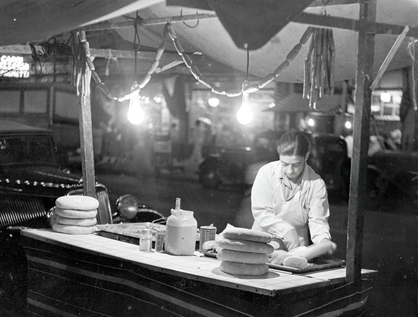 An Italian Street Vendor Selling Hot Dogs At Night In Harlem, 1935.