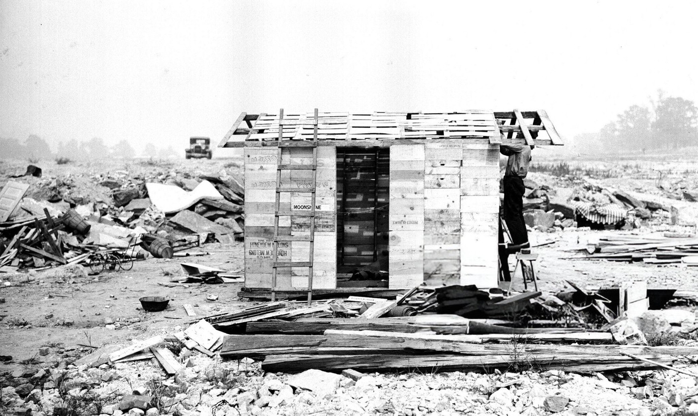 James Muller, unemployed for two years, adds a roof to the home he built of discarded lumber in the swamplands of Jamaica Bay.