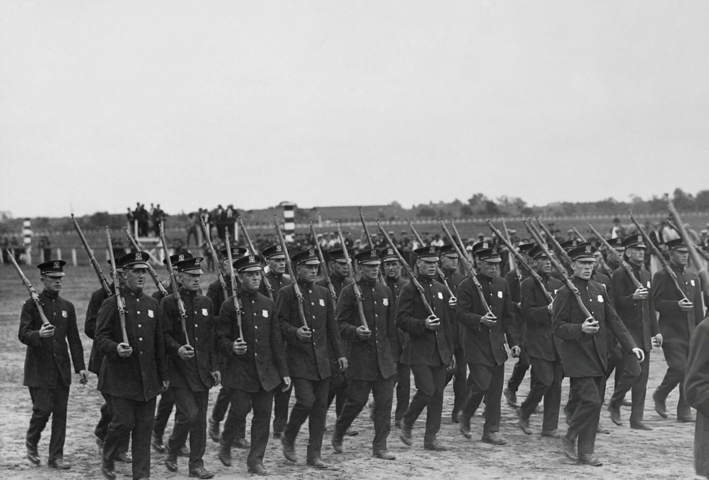 NYPD officers march past the reviewing stand during their carnival and field day at Jamaica Race Course in Queens, circa 1935.