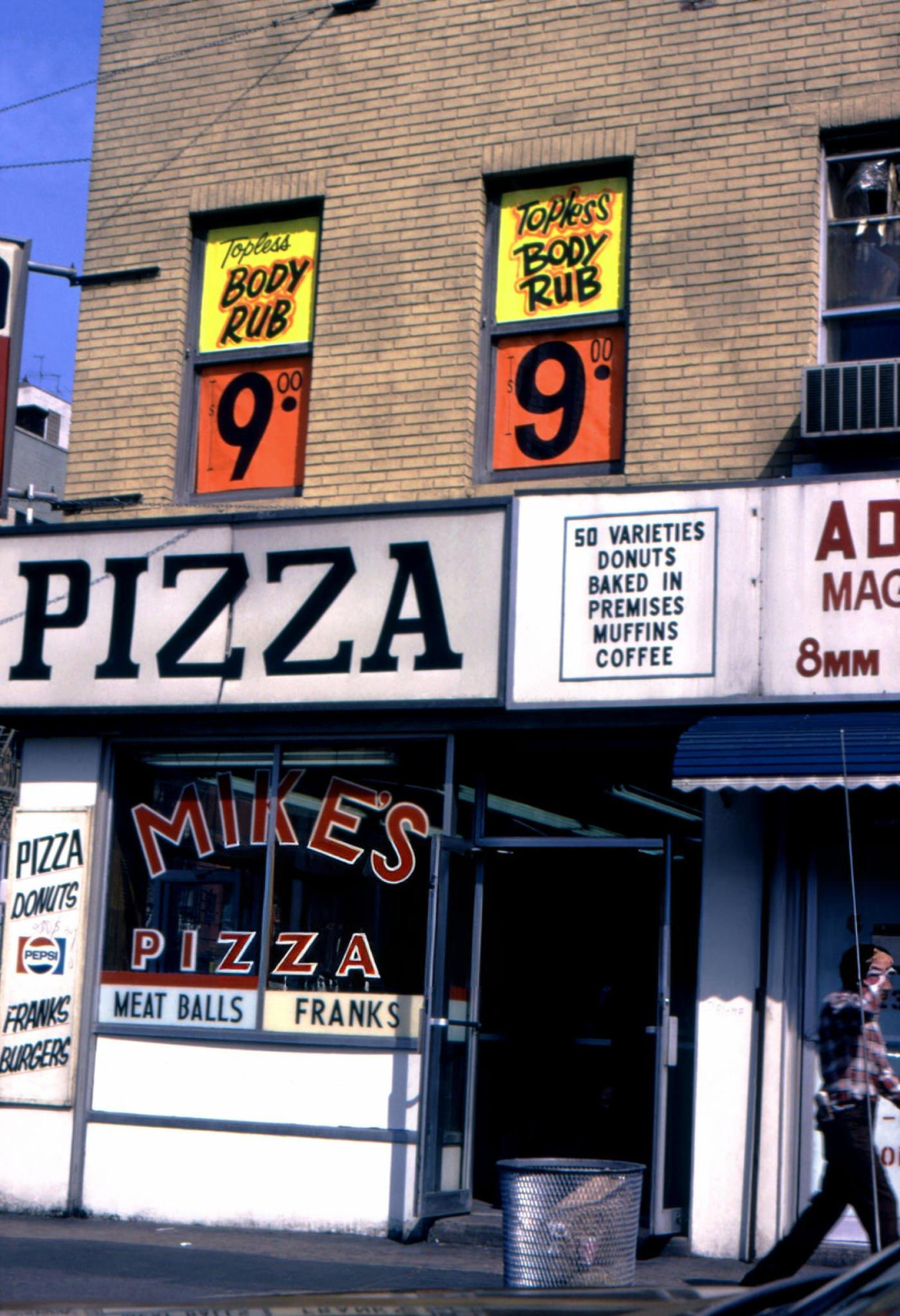 A Pedestrian Passes Mike'S Pizza And A Topless Massage Parlor In Lower Manhattan, 1975.