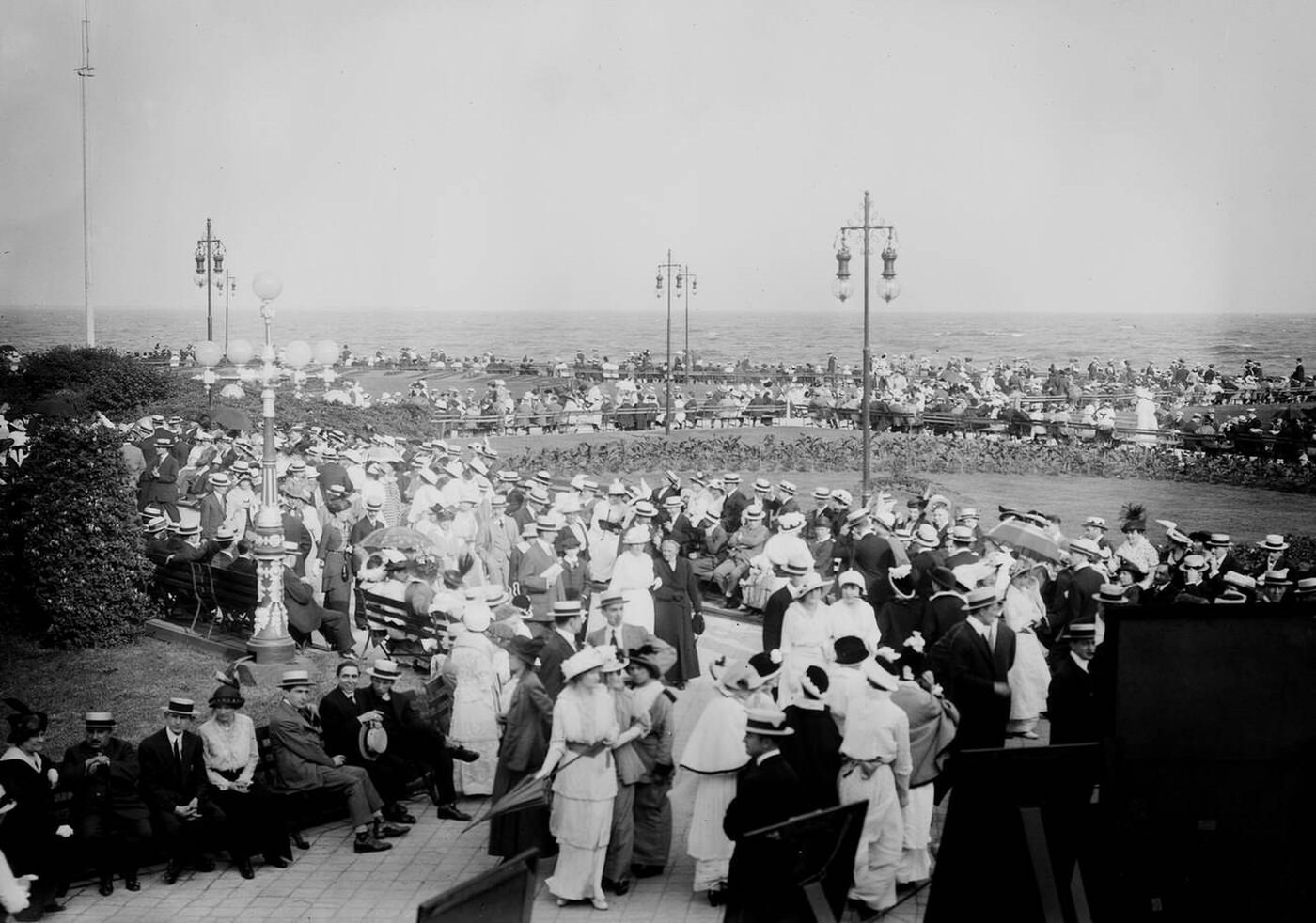 People On Brighton Beach Enjoying A Day In The Sun, 1910.