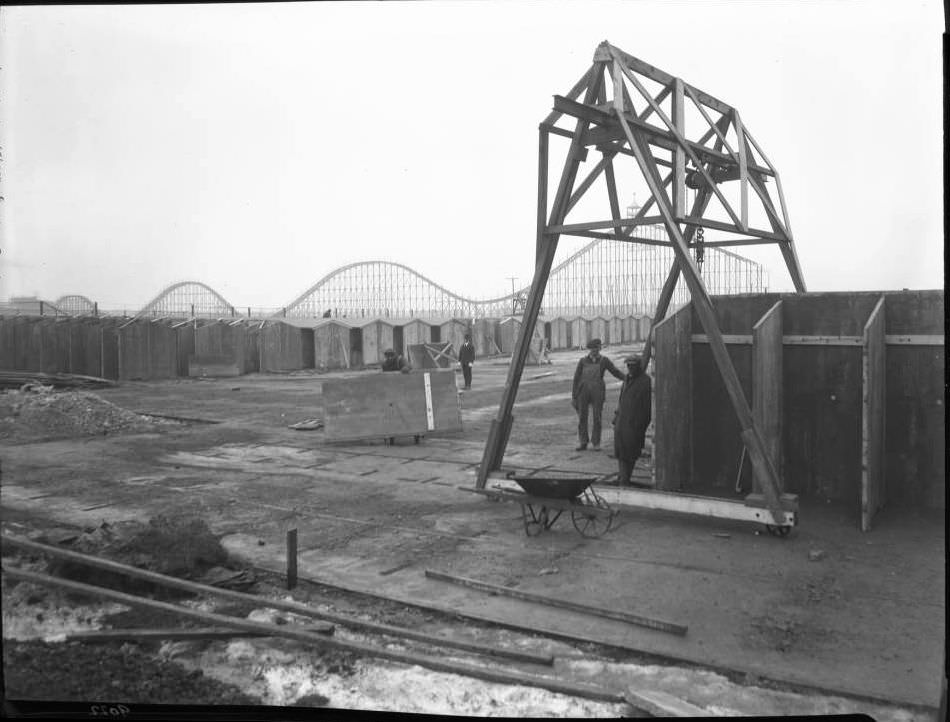Construction Workers Pose On Construction Site With Roller Coaster In Background, Brighton Beach, 1920.