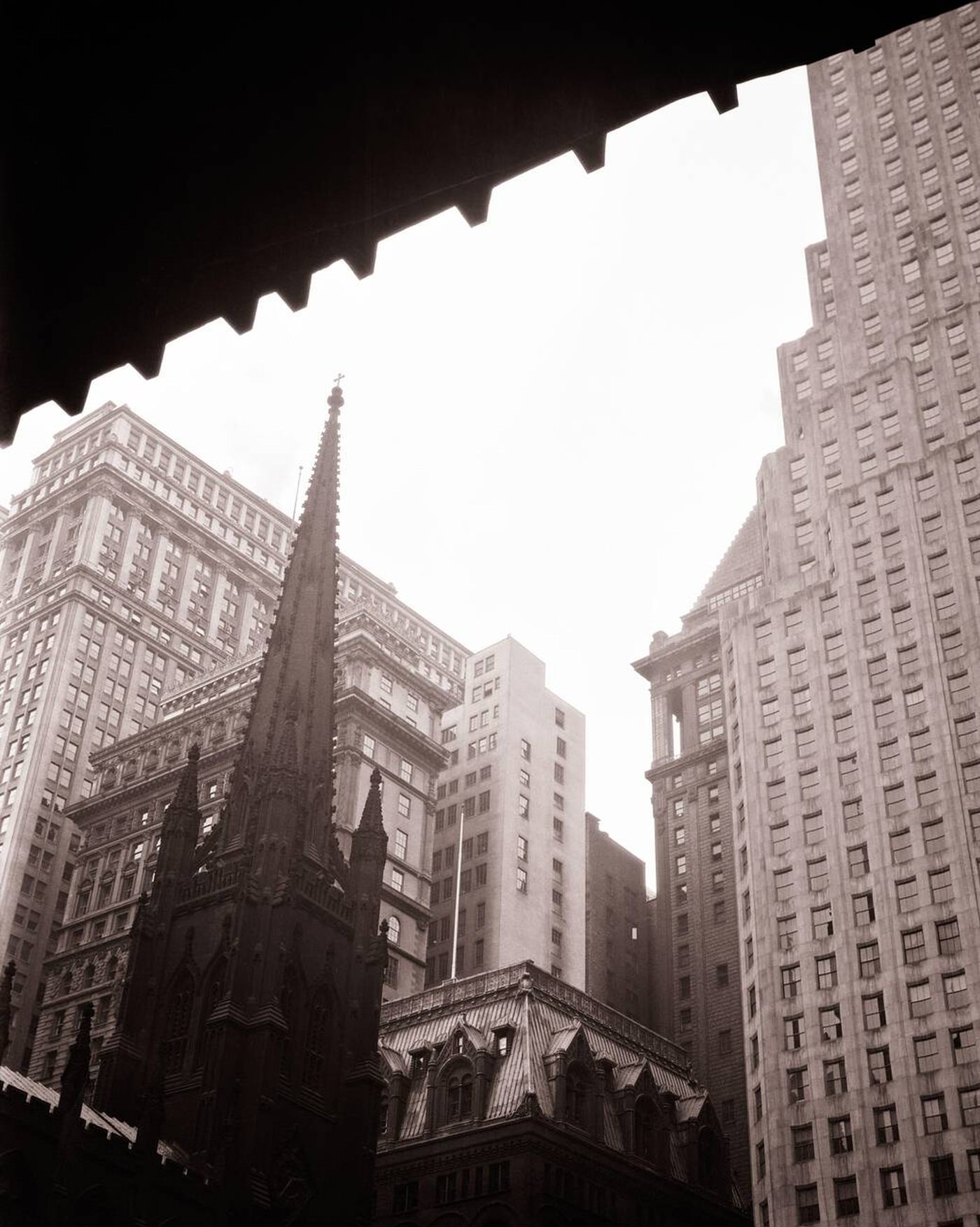 Spire Of Trinity Church In Center Of Buildings At Wall Street And Broadway, New York City, 1920S.