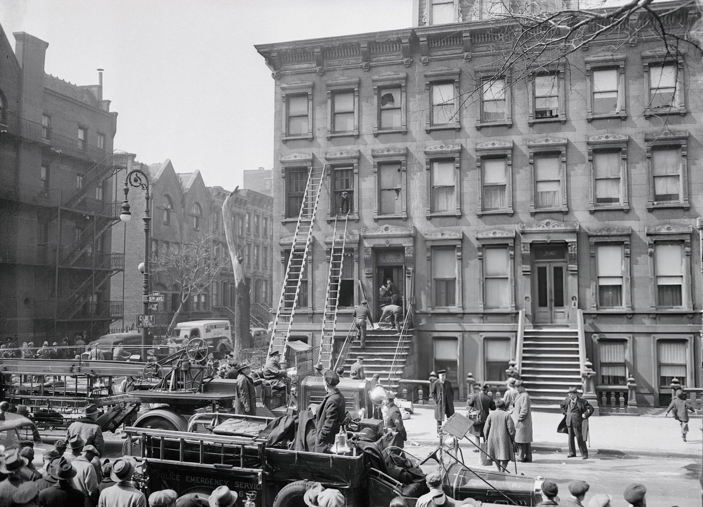 Crowd Watching Police Remove A Body From A House
