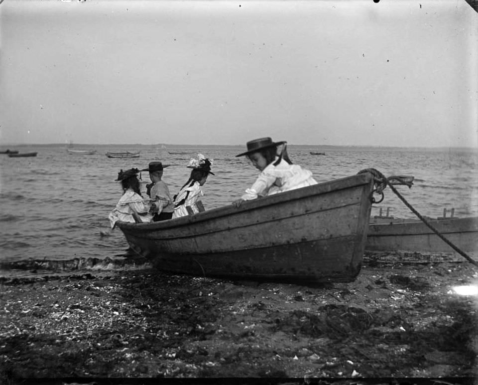 Grace And Willie Stonebridge With A Little Girl And Boy In A Rowboat On The Beach, Lohbauer Park, Throggs Neck, Pelham Bay, Bronx, 1898.