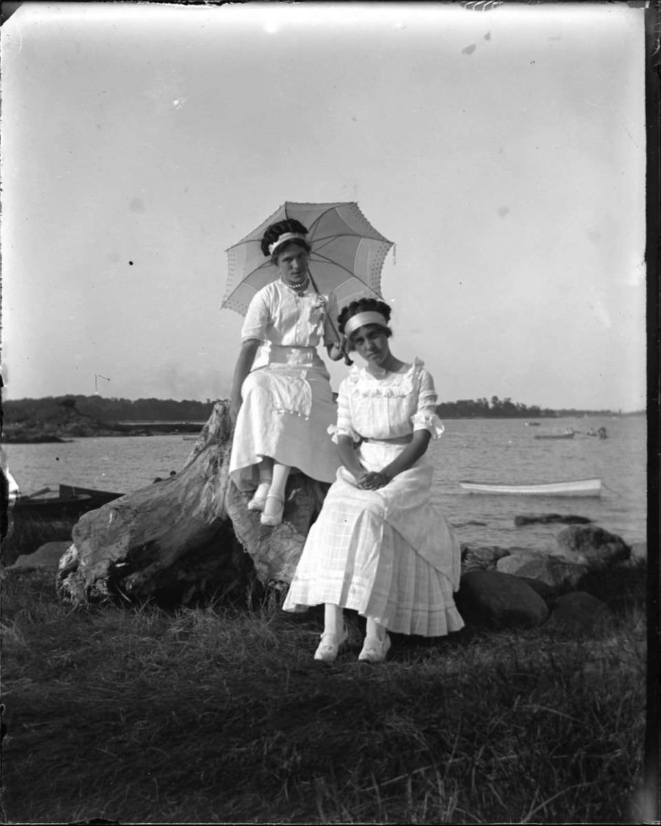 Grace Stonebridge And A Person Seated On Driftwood At Orchard Beach, Bronx, 1911.