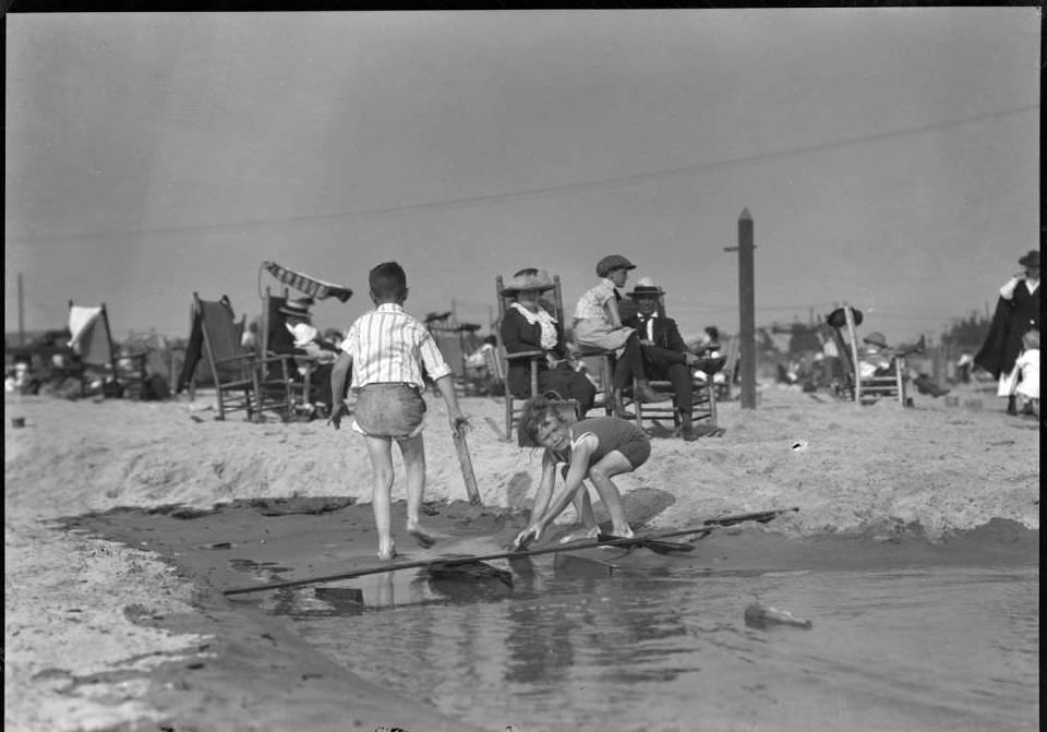 Children Playing In Wet Sand, Brighton Beach, Brooklyn, Ca. 1920.