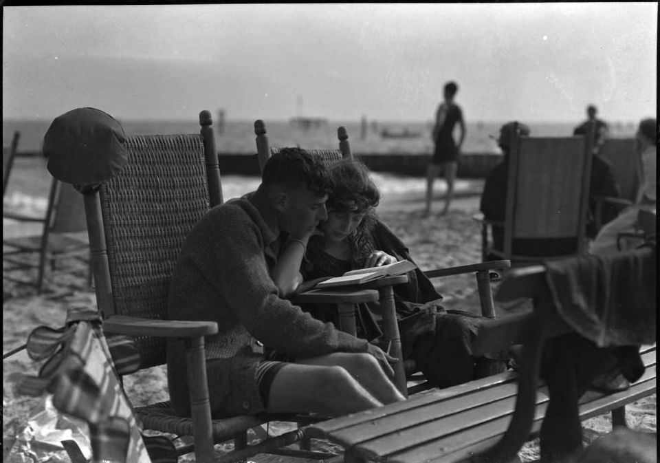 Young Couple In Beach Chairs Read A Book Together, Brighton Beach, Brooklyn, Ca. 1920.