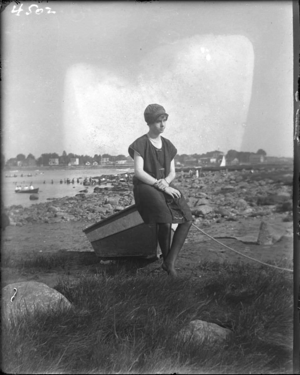 Girl In A Bathing Suit Sitting On A Beached Boat At Orchard Beach, Bronx, 1915.