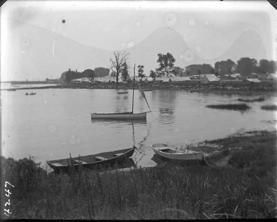 Small Boats Moored In Bay With Campsites Beyond, Orchard Beach, Bronx, 1908.