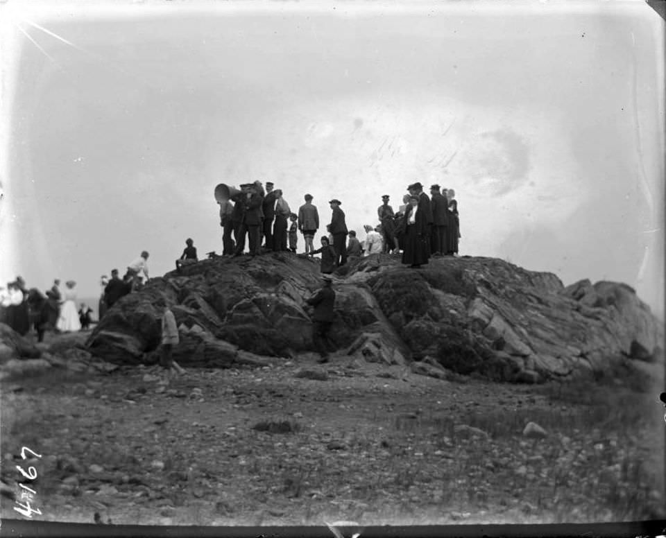 Crowd Gathered On Beach Rocks, Orchard Beach, Bronx, 1907.