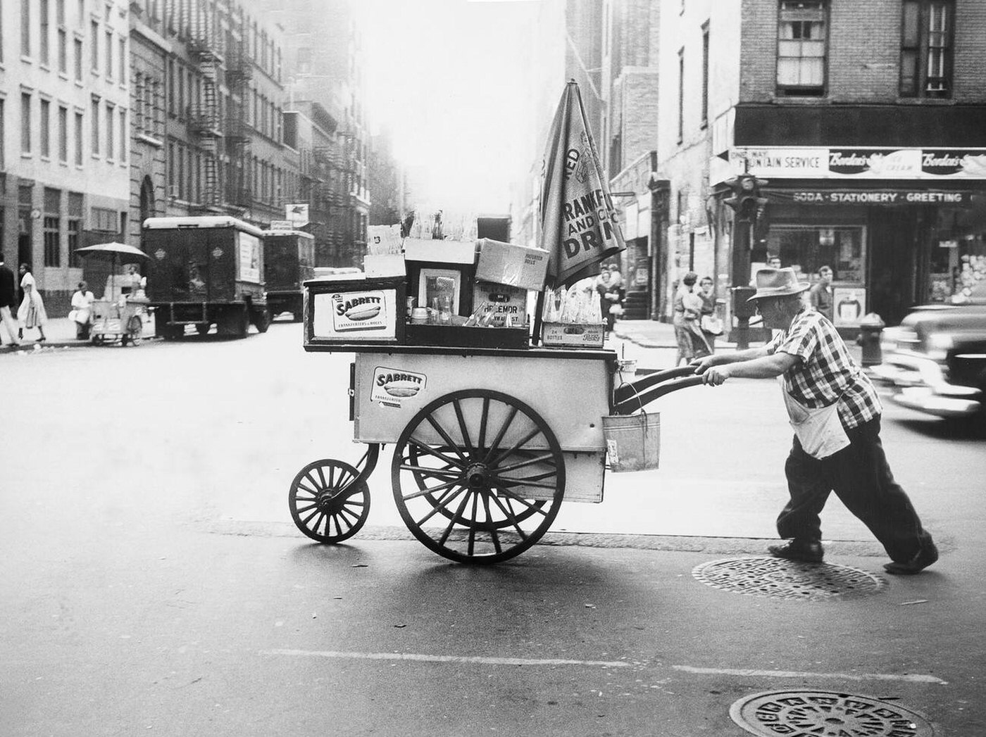 Man Pushing Hot Dog Cart Across Street, New York City, September 1957.