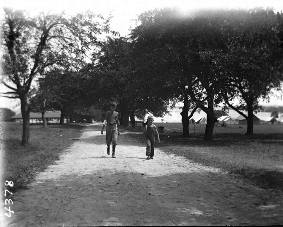 Two Unidentified Boys Walking On Macadam Road At Orchard Beach, Bronx, 1910.
