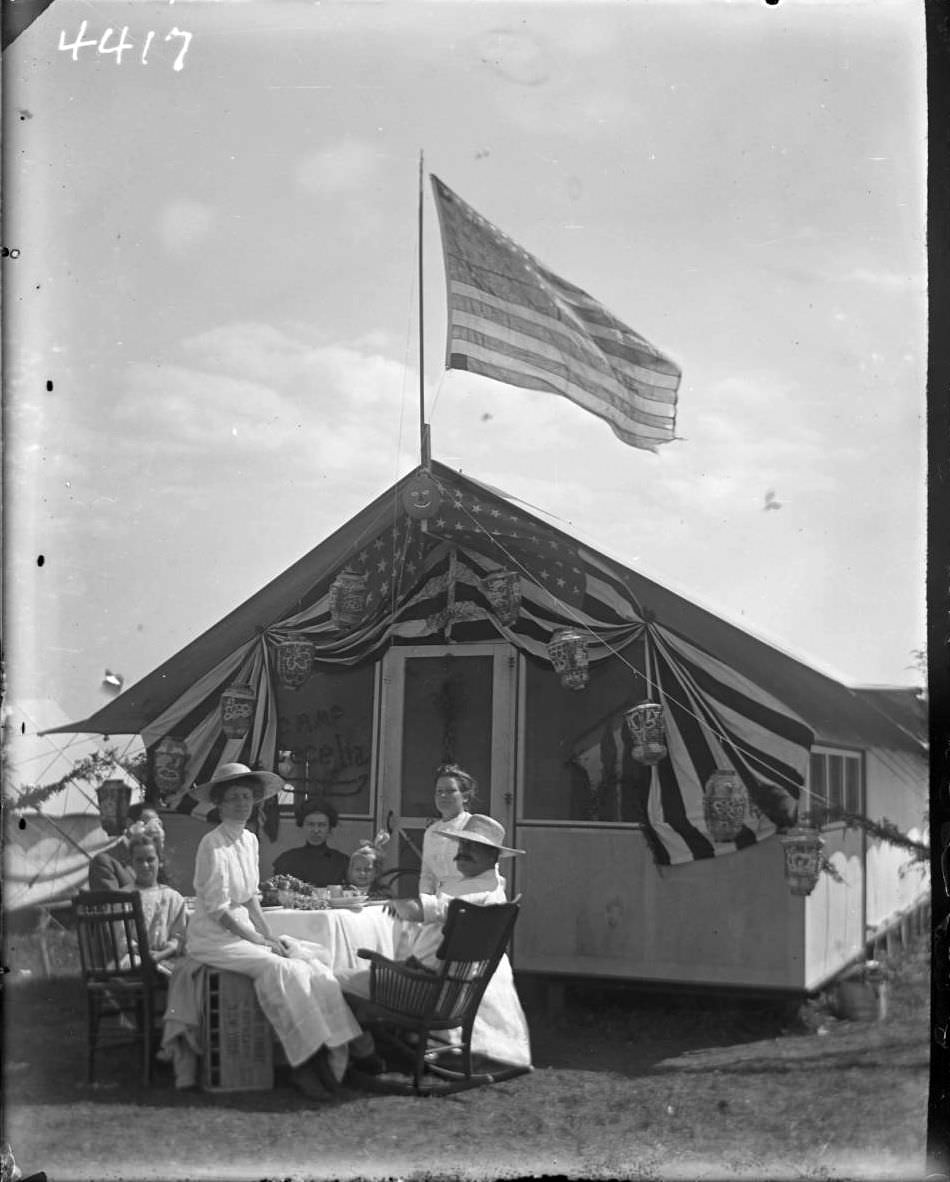 Tent 'Camp Cecelia' Decorated For Labor Day With Unidentified Family Seated In Front At Orchard Beach, Bronx, 1910.