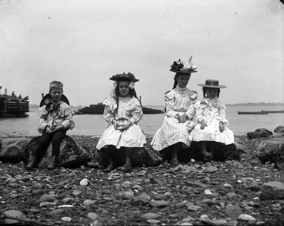 Grace And Willie Stonebridge With A Little Girl And Boy Sitting On Rocks At The Beach, Lohbauer Park, Throggs Neck, Pelham Bay, Bronx, 1898.