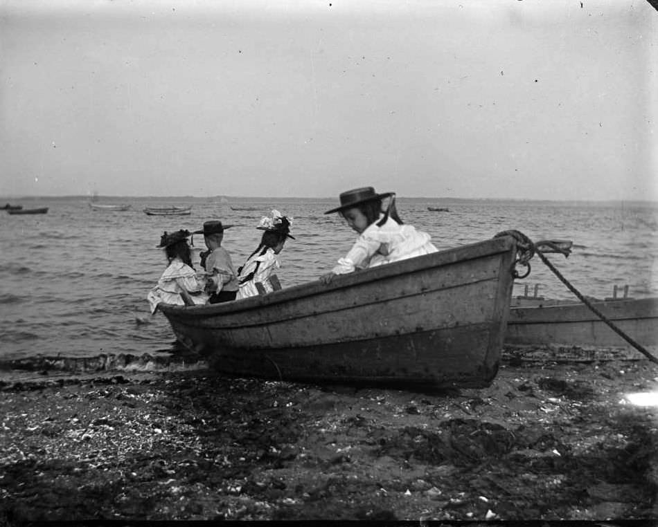 Grace And Willie Stonebridge With A Little Girl And Boy In A Row Boat On The Beach, Lohbauer Park, Throggs Neck, Pelham Bay, Bronx, 1898.