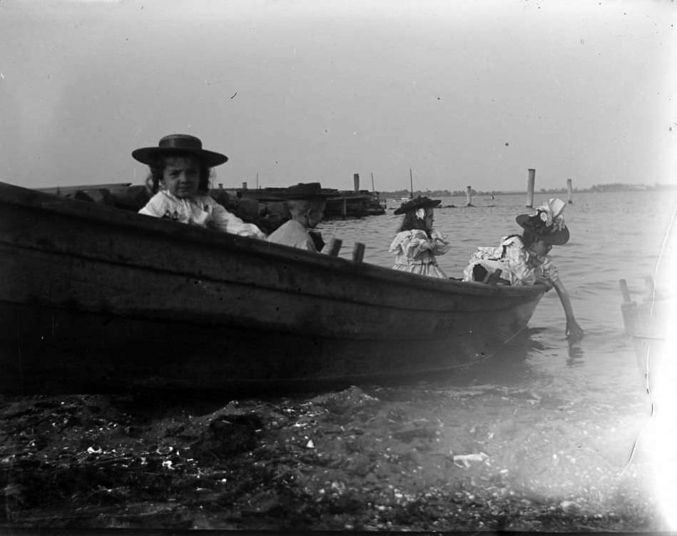 Grace And Willie Stonebridge With A Little Girl And Boy In A Row Boat On The Beach, Lohbauer Park, Throggs Neck, Pelham Bay, Bronx, 1898.