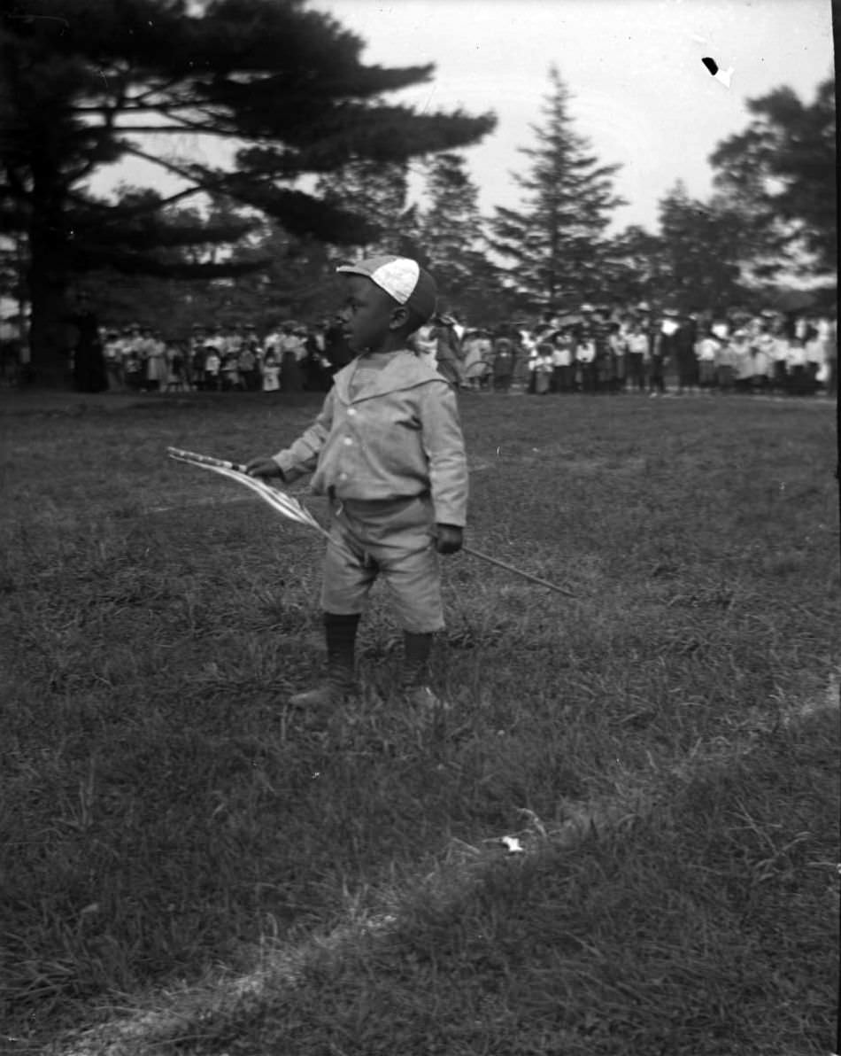 An African American Boy With A Flag At The Sunday Schools Parade In Claremont Park, Bronx, 1903.