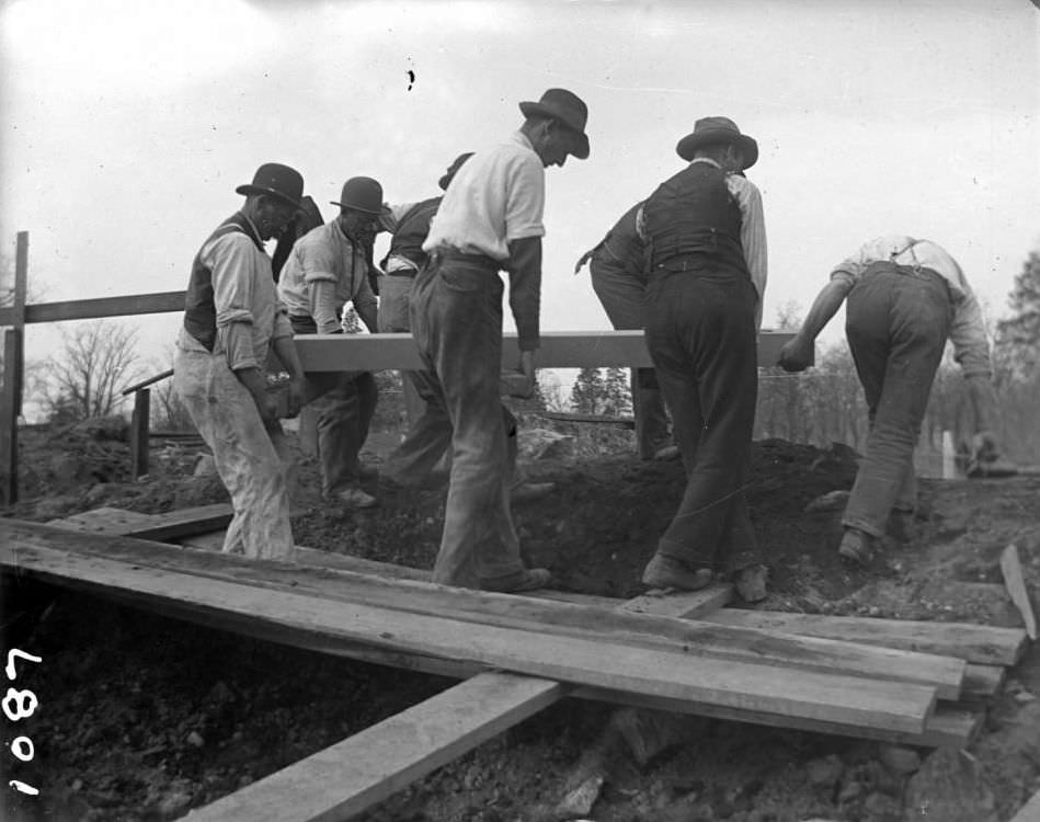 Laborers Carrying A Length Of Cut Stone During The Construction Of The New York Zoological Gardens, Bronx, 1890S.