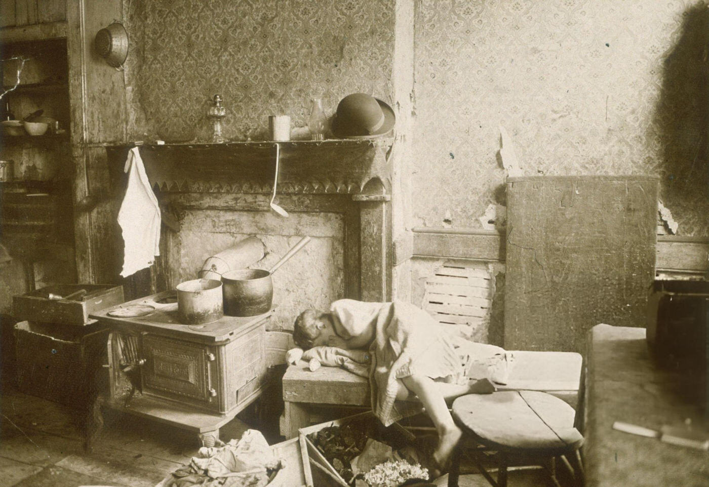 A Child Slumped Over A Bench In A Dilapidated Tenement Apartment On The Lower East Side, 1896.