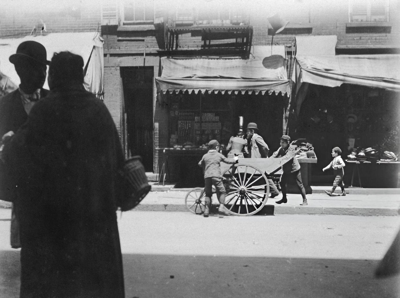 Two Young Boys Steal Items From A Vendor'S Pushcart On Hester Street In The Lower East Side, 1900.