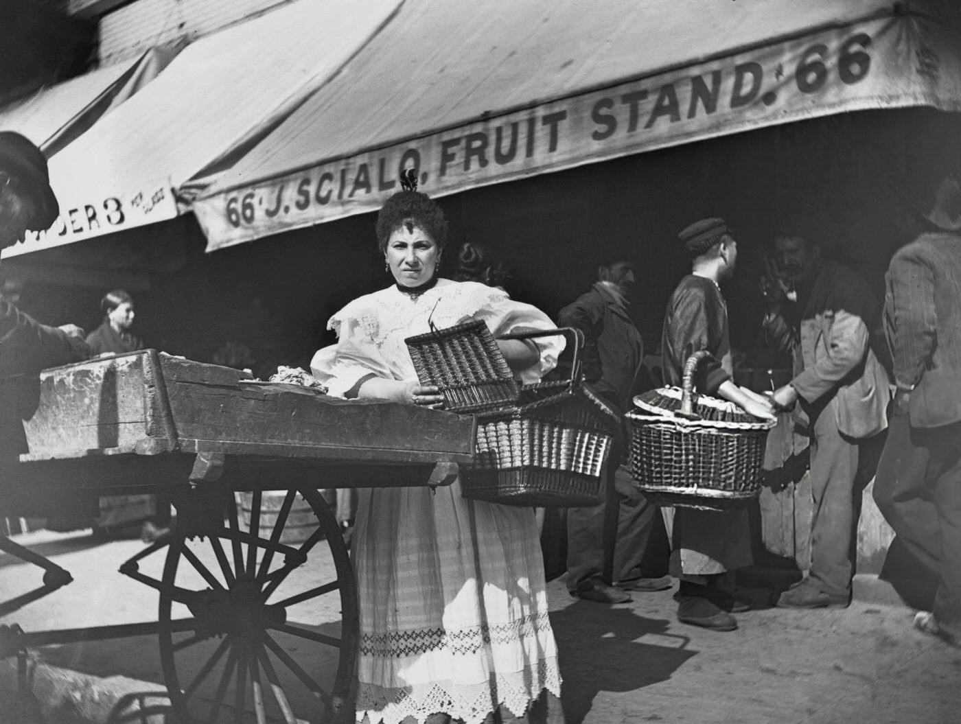 A Woman Buying From A Pushcart Vendor In A Market On Mulberry Street, 1900.
