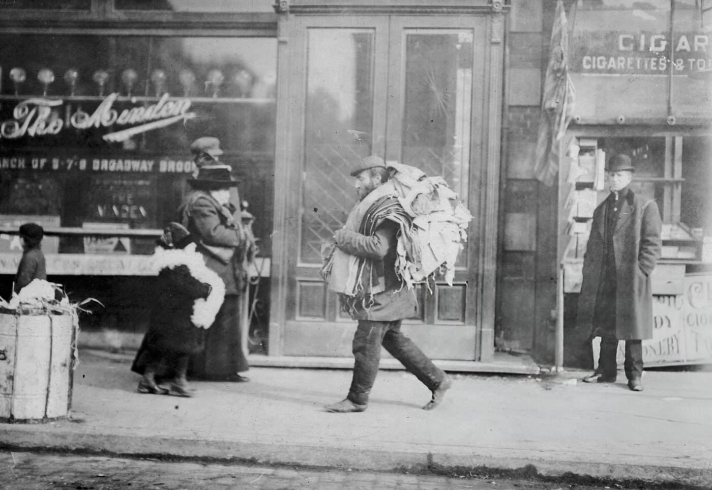 On Delancey Street, A Man Carries A Load Of Garment Parts For Home Work Over His Shoulders, 1912.