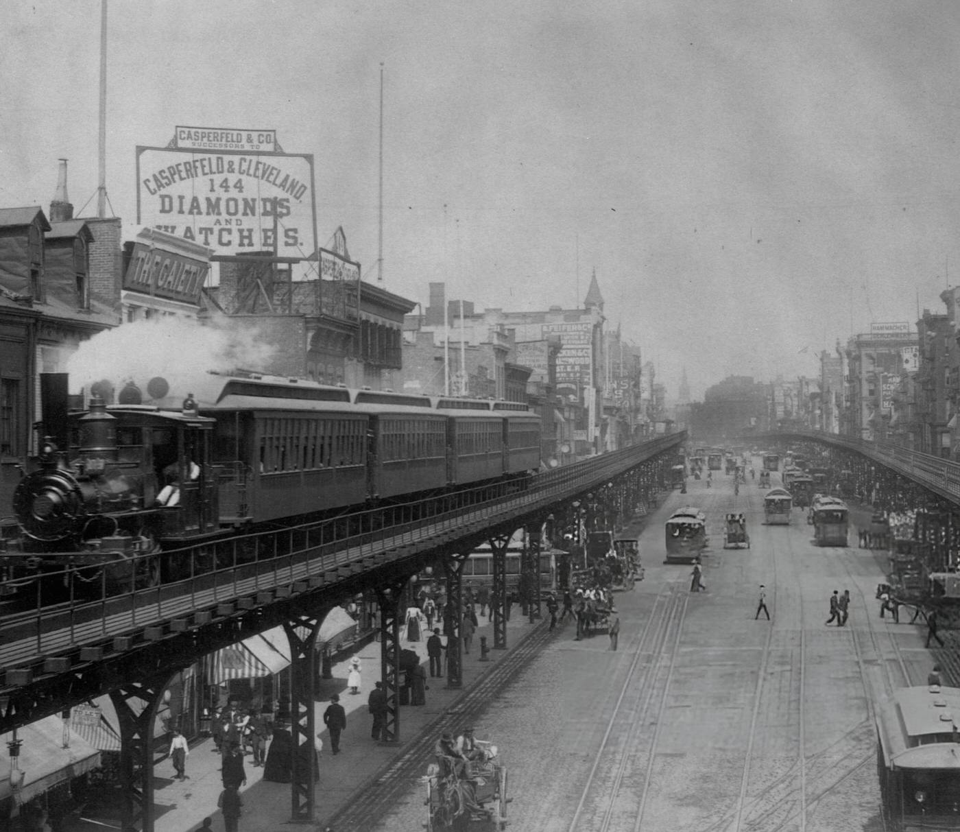 Elevated Trains Roll Over Busy Streets In The Bowery, Manhattan.