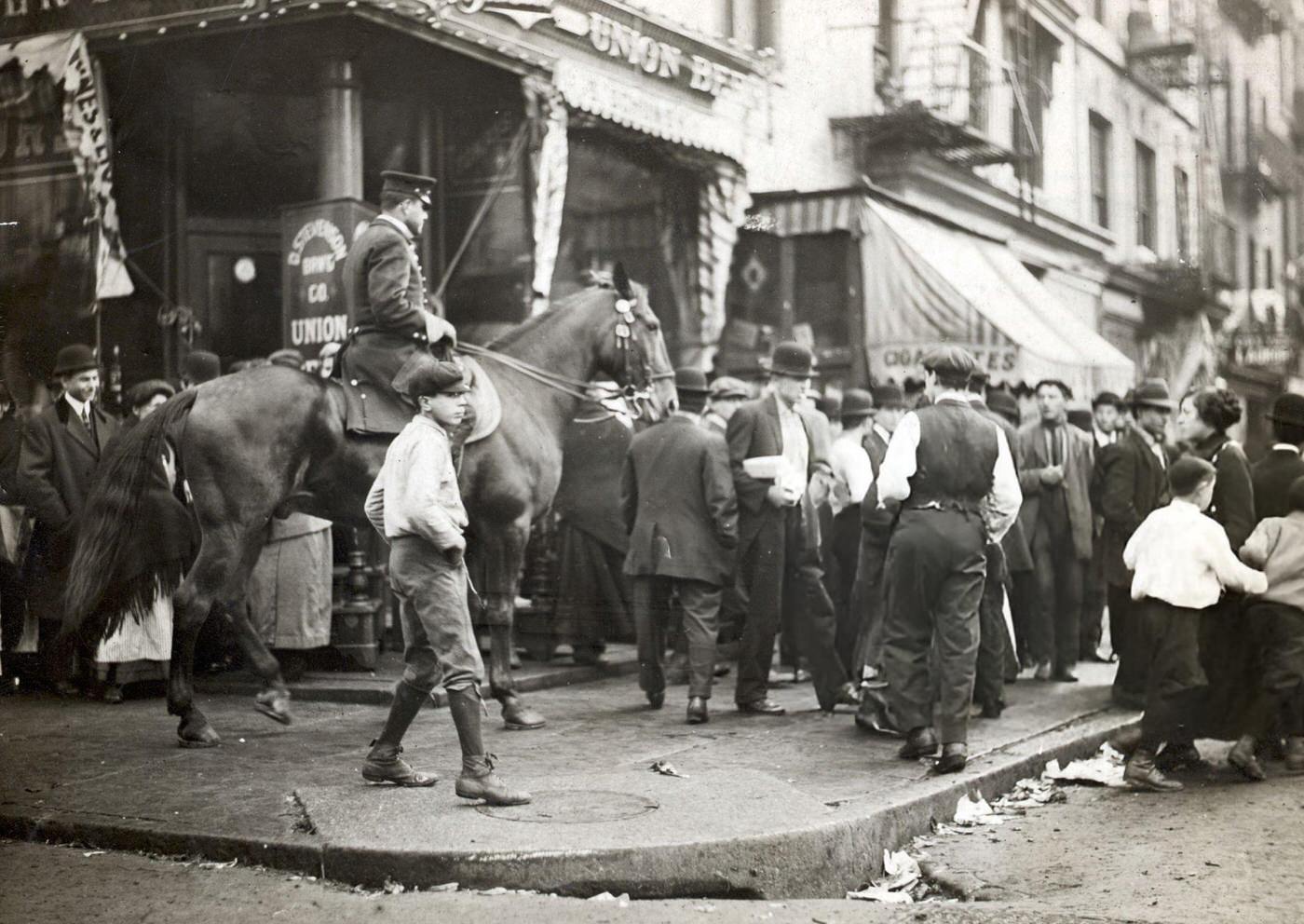 Policeman Clears Sidewalk On The Lower East Side, 1907.