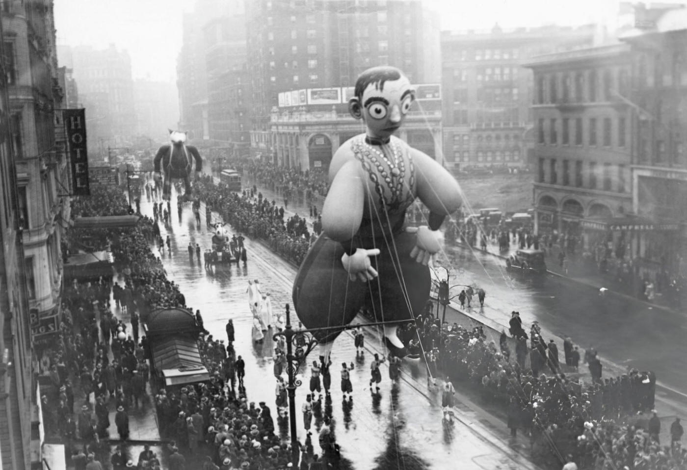 A Giant Eddie Cantor Balloon, Followed By The Big Bad Wolf, In Macy'S Thanksgiving Day Parade, New York City, 1934.