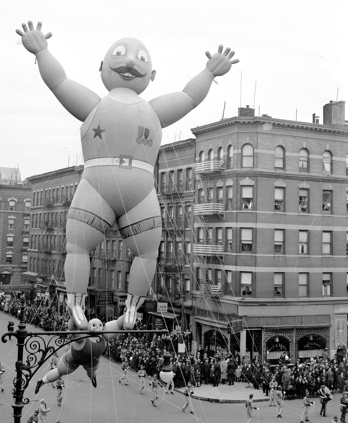 The Prize-Winning &Amp;Quot;Little Man-Big Man&Amp;Quot; (Aka The Acrobats) Balloon, Designed By 12-Year-Old Rudolf Lopez, Passes 106Th St. And Central Park West In Macy'S Thanksgiving Day Parade, 1938.