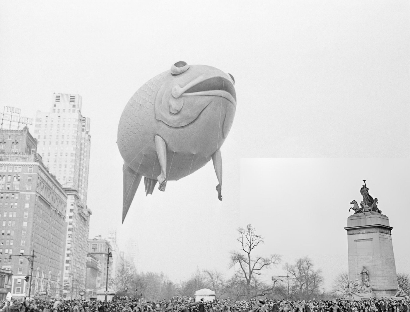 Throngs Of New Yorkers In Columbus Circle Gape As A Flying Goldfish Swings Onto Broadway From Central Park West During The Macy Thanksgiving Parade, 1940S.