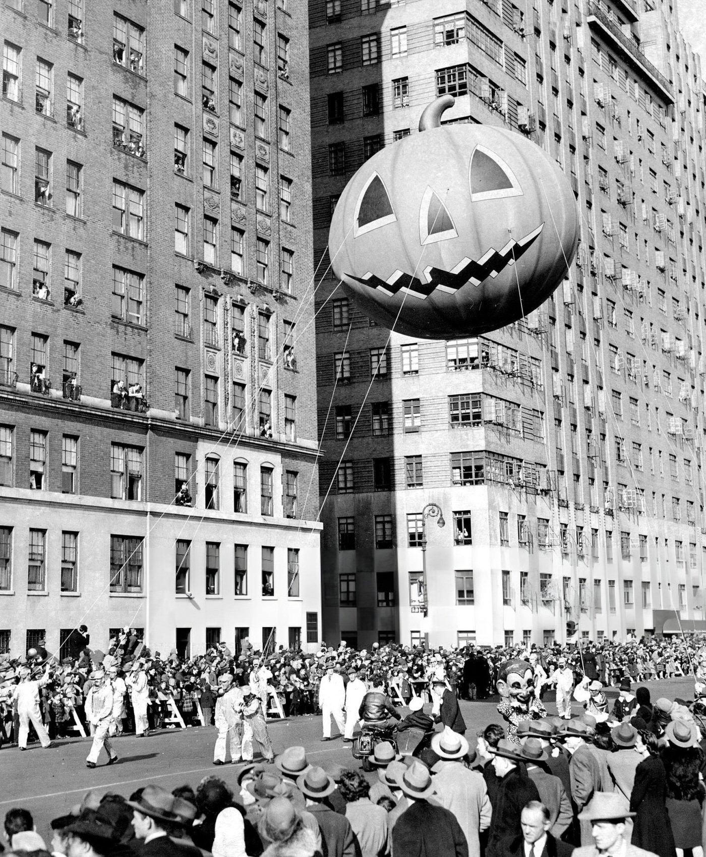Spectators Lean From Windows As A Mammoth Pumpkin Balloon Passes By In Macy'S Thanksgiving Day Parade, 1945.