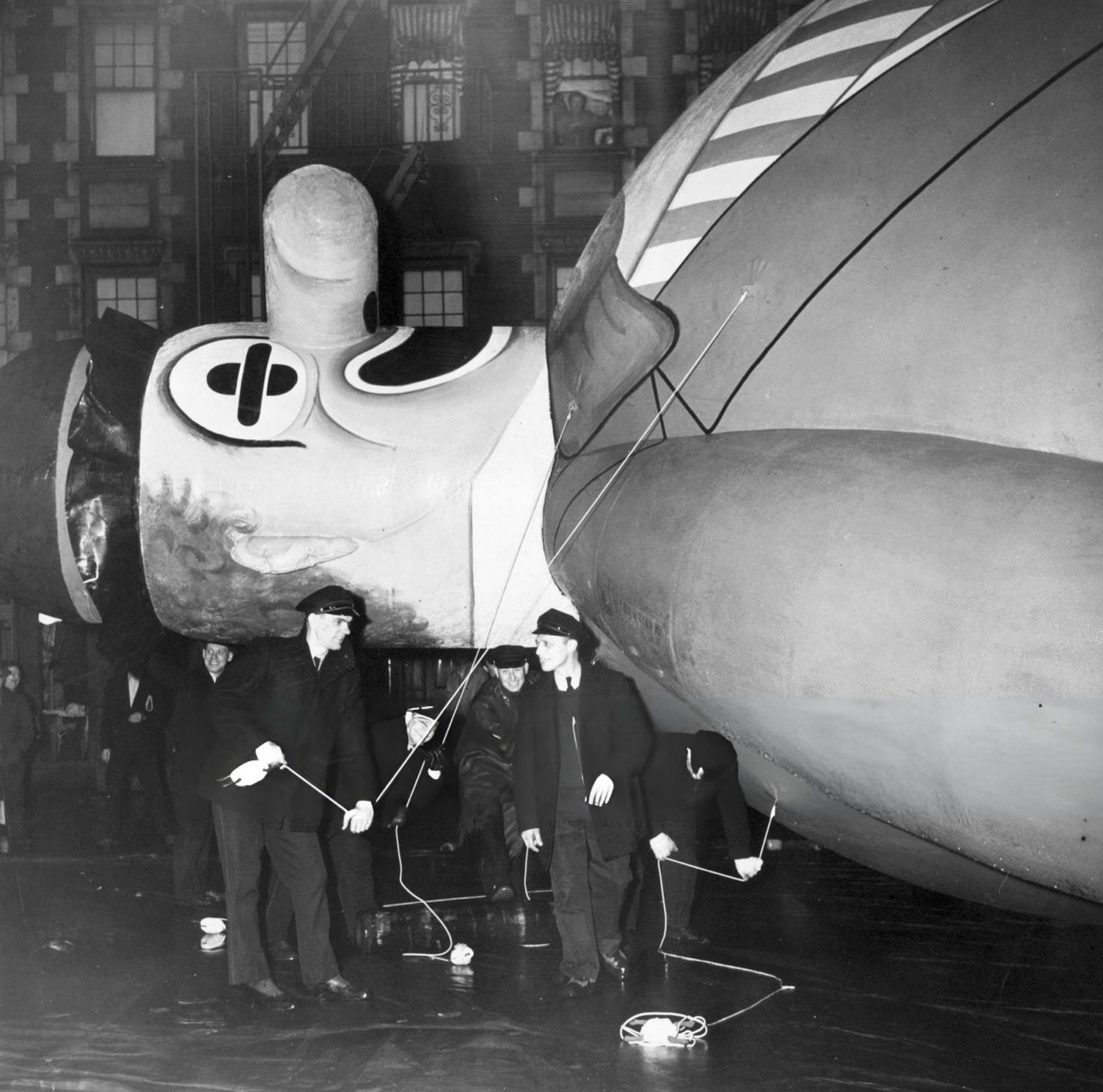 Balloon Handlers Hold The Ropes Of The Helium-Filled Bobo The Hobo Balloon In Preparation For The Annual Macy'S Thanksgiving Day Parade, New York, 1945.