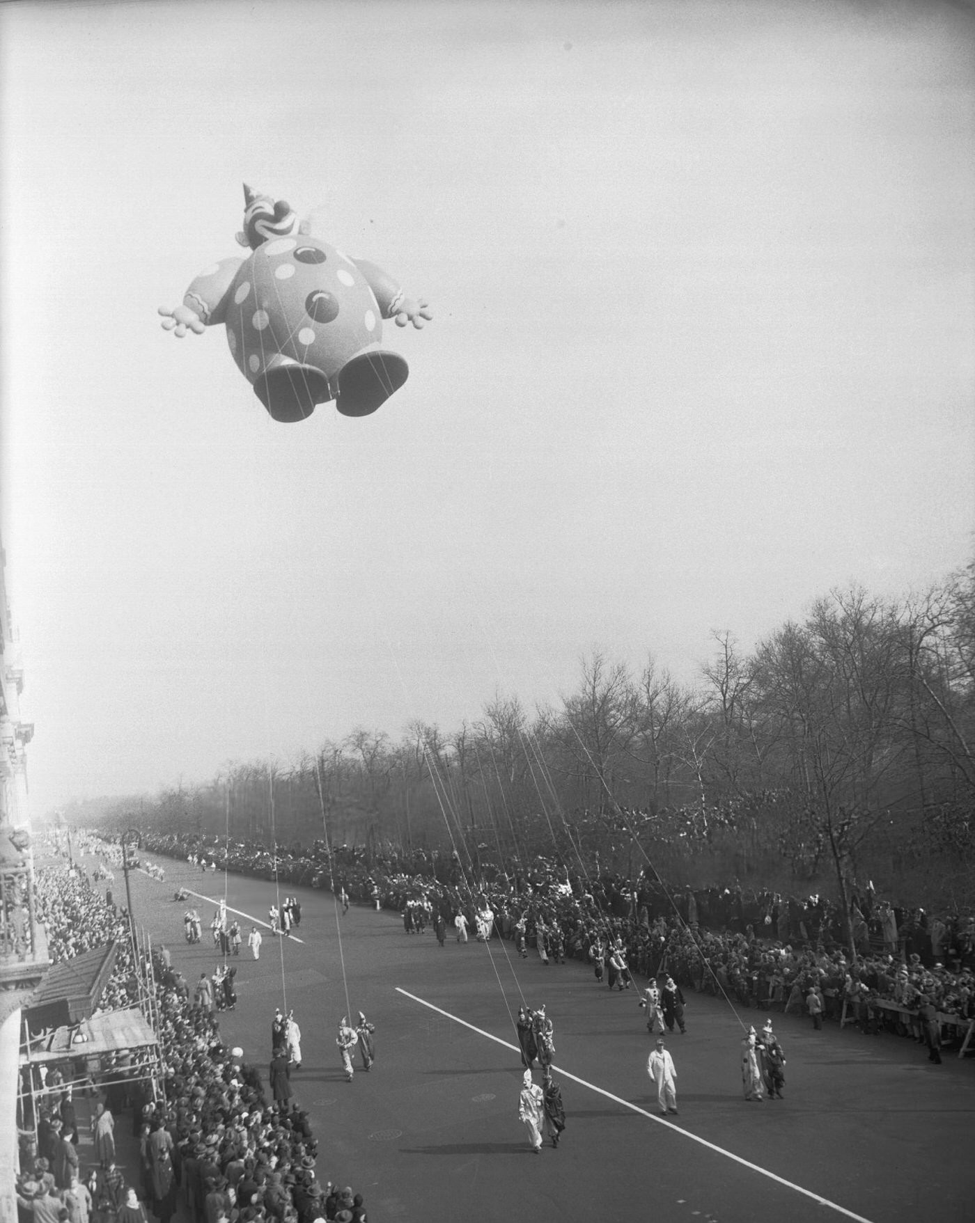A Giant Clown Balloon Flies High Over The Crowd Watching The Macy'S Thanksgiving Day Parade On Central Park West In New York City.