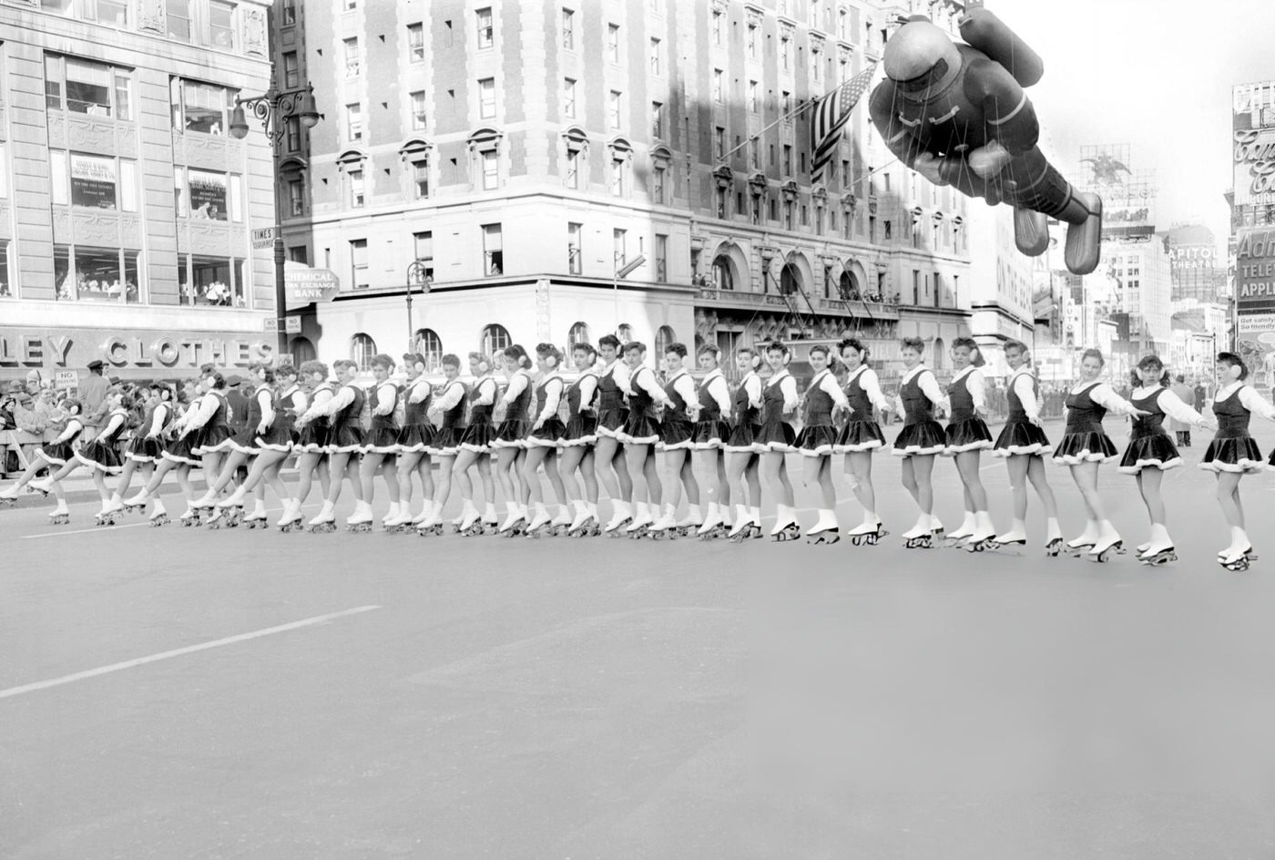 A Spaceman Balloon Hovers Over Short-Skirted Skaters As They Prepare To Roll Towards Macy'S Thanksgiving Day Parade In Times Square, 1956.