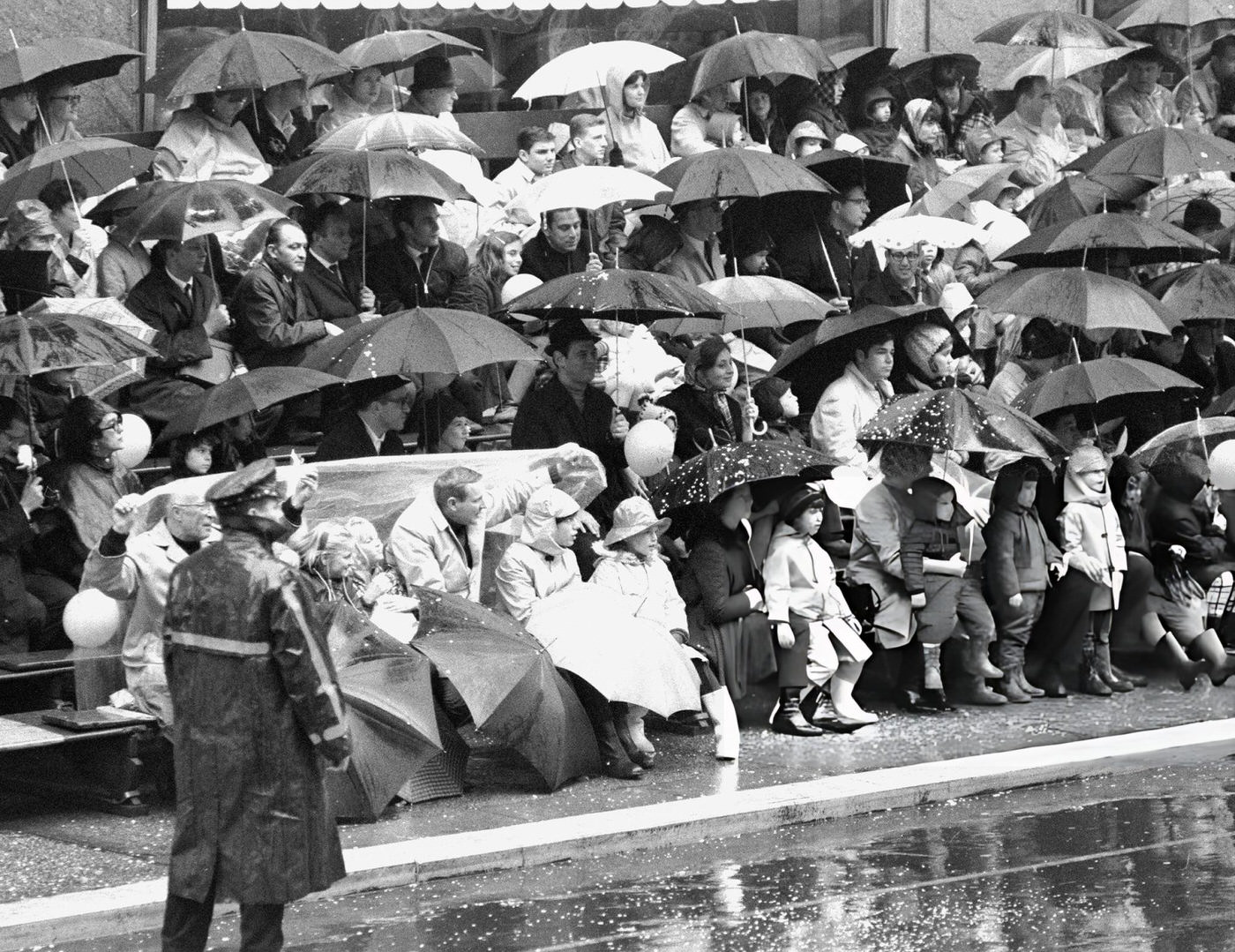 Police Officers And Spectators With Umbrellas Indicate The Rainy Weather At Macy'S Thanksgiving Day Parade, 1963.