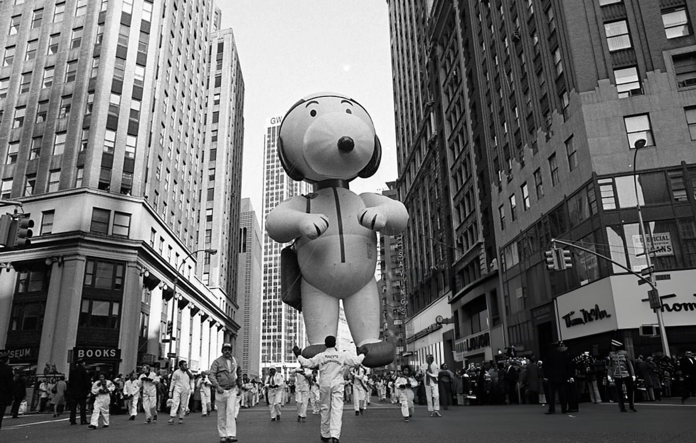 A Snoopy Balloon Floats Above Broadway During The 1974 Thanksgiving Day Parade, New York, 1974.