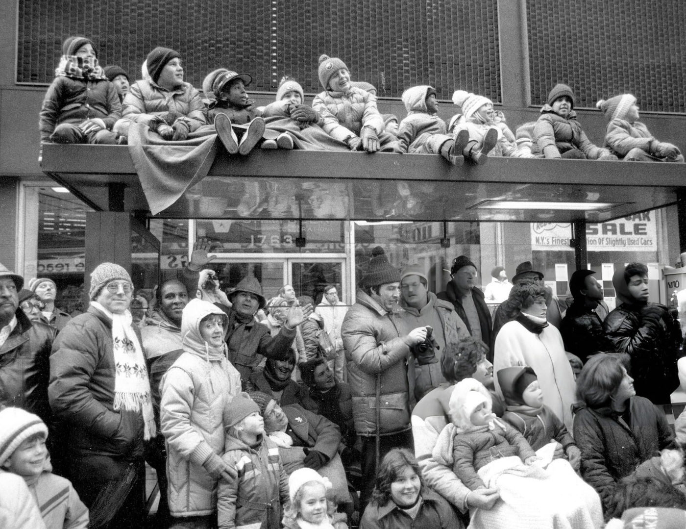 Children Sit On A Roof Atop A Van To Get A Better View Of The Macy'S Thanksgiving Day Parade.