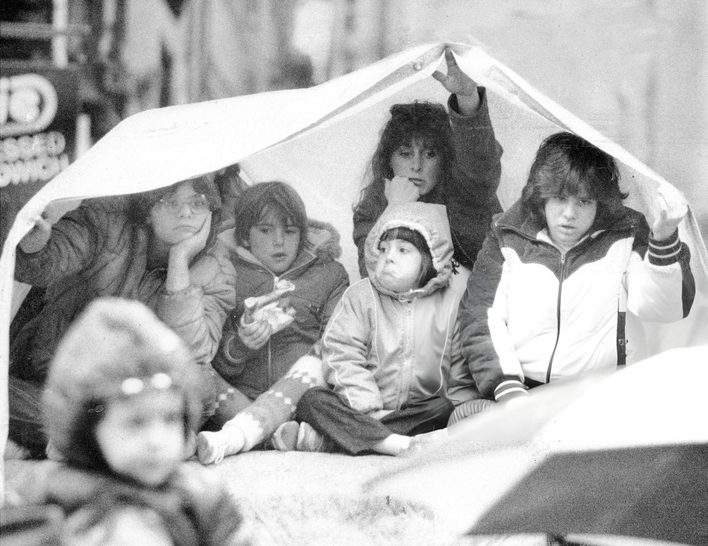 Kids Huddle Under A Tarp Atop A Van To Watch The Macy'S Thanksgiving Day Parade.