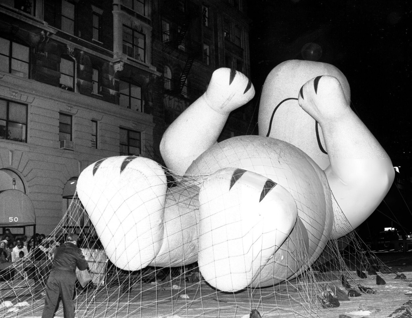 A 50-Foot-High Balloon Version Of The Cartoon Character Snoopy Appears To Be Resting Before The Macy'S Thanksgiving Day Parade.